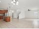 Open-concept floor plan with a view of the kitchen, dining area, and access to the staircase at 1893 Rafton Rd, Apopka, FL 32703