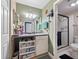 Bathroom featuring a vanity with storage, a mirror with updated lighting, and a glass-enclosed shower at 200 Maitland Ave # 228, Altamonte Springs, FL 32701