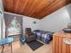 Bedroom featuring wood ceilings, wood floors, and comfortable seating near a window at 200 Maitland Ave # 228, Altamonte Springs, FL 32701