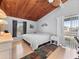 Bedroom featuring wood ceilings, neutral paint, and a sliding glass door leading to a balcony at 200 Maitland Ave # 228, Altamonte Springs, FL 32701