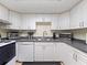 Well-lit kitchen with white cabinets, ample counter space, and essential appliances at 200 Maitland Ave # 228, Altamonte Springs, FL 32701