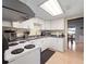 Bright kitchen features white cabinets, functional appliances, and a clear view of the dining area at 200 Maitland Ave # 228, Altamonte Springs, FL 32701