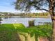 Scenic lake view with mature trees and a green lawn at 200 Maitland Ave # 228, Altamonte Springs, FL 32701