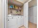Functional laundry room with shelving and side access to the bedroom closet at 200 Maitland Ave # 228, Altamonte Springs, FL 32701