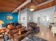 Living room featuring wood ceilings, comfortable seating, and an adjacent dining area at 200 Maitland Ave # 228, Altamonte Springs, FL 32701