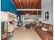 Open living room featuring wood ceilings, comfortable seating, and a bright workspace at 200 Maitland Ave # 228, Altamonte Springs, FL 32701