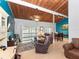 Comfortable living room featuring wood ceilings, a ceiling fan, and a sliding door to the balcony at 200 Maitland Ave # 228, Altamonte Springs, FL 32701