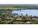 An aerial view showcasing the lake, docks, and homes nestled amongst the mature trees and lush greenery at 2008 Water Key Dr, Windermere, FL 34786