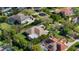 An aerial view of the home highlighting the backyard swimming pool with screened enclosure and verdant landscaping at 2008 Water Key Dr, Windermere, FL 34786