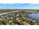 An expansive aerial view of the community showcasing the lake, mature trees, and homes at 2008 Water Key Dr, Windermere, FL 34786