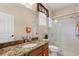 Bright bathroom featuring a granite vanity, white cabinets, and glass enclosed shower at 2008 Water Key Dr, Windermere, FL 34786