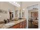 Bathroom with double vanity, granite counters, and decorative mirrors at 2008 Water Key Dr, Windermere, FL 34786