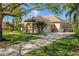 Charming home with well-manicured lawn, tile roof, and extended driveway lined with lush landscaping at 2008 Water Key Dr, Windermere, FL 34786