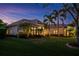 Beautifully landscaped home at dusk features palm trees and soft exterior lighting at 2008 Water Key Dr, Windermere, FL 34786