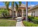 Charming home with a tile roof, complemented by well-manicured landscaping and a welcoming walkway at 2008 Water Key Dr, Windermere, FL 34786