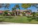 Beautifully landscaped front yard with lush green grass and mature trees surrounding the home at 2008 Water Key Dr, Windermere, FL 34786