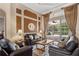 Comfortable living room showcasing hardwood floors, decorative wall, and screened-in pool views at 2008 Water Key Dr, Windermere, FL 34786