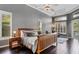 This main bedroom boasts a king bed, tray ceilings, ceiling fan, and beautiful windows at 2008 Water Key Dr, Windermere, FL 34786