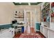 Bright office space with built-in shelves, hardwood floors, and green and tan walls at 2008 Water Key Dr, Windermere, FL 34786