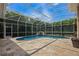 Screened in pool area with travertine tile and waterfall feature with beautiful landscaping at 2008 Water Key Dr, Windermere, FL 34786