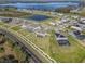 Expansive aerial view showcases the community layout with lake views and well-maintained properties at 2189 Weatherly Way, Orlando, FL 32820