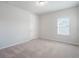 Bedroom with neutral walls, plush carpet, a window and a door at 2189 Weatherly Way, Orlando, FL 32820