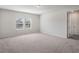 Spacious bedroom with neutral carpet, two windows providing natural light, and white walls at 2189 Weatherly Way, Orlando, FL 32820