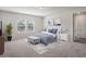 Comfortable bedroom featuring a plush bed with blue accents, side tables, and natural light at 2189 Weatherly Way, Orlando, FL 32820