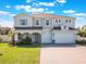 Charming two-story home with a three-car garage and well-manicured front yard at 2189 Weatherly Way, Orlando, FL 32820