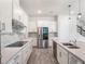 Gourmet kitchen with a tile backsplash, white cabinets, and stainless steel appliances at 2189 Weatherly Way, Orlando, FL 32820