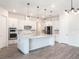 Modern kitchen with large island, pendant lighting, and stainless steel appliances at 2189 Weatherly Way, Orlando, FL 32820