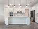 Modern kitchen with white cabinetry, stainless steel appliances, and a center island at 2189 Weatherly Way, Orlando, FL 32820