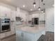 Spacious kitchen with white cabinetry, quartz countertops, and stainless steel appliances at 2189 Weatherly Way, Orlando, FL 32820