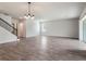 Open-concept living area with wood-look tile floors and staircase at 2189 Weatherly Way, Orlando, FL 32820