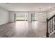 Open-concept living area with wood-look tile floors leading to outdoor spaces at 2189 Weatherly Way, Orlando, FL 32820
