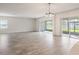 Bright and airy living space featuring sliding glass doors and wood-look tile flooring at 2189 Weatherly Way, Orlando, FL 32820