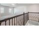 View from the top of the staircase highlighting the carpeted loft area and decorative iron railing at 2189 Weatherly Way, Orlando, FL 32820