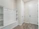 Functional mudroom featuring custom built-ins with storage and a bench, ideal for organization at 2189 Weatherly Way, Orlando, FL 32820