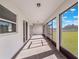 Enclosed patio with brick flooring, offering an ideal outdoor living space with views of the backyard at 2189 Weatherly Way, Orlando, FL 32820