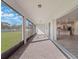 Covered patio with brick flooring leads to an open-concept living and kitchen area at 2189 Weatherly Way, Orlando, FL 32820