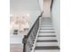 Elegant staircase with dark wood treads, white risers, and decorative iron railing leading to the upper level at 2189 Weatherly Way, Orlando, FL 32820