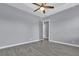 Spacious bedroom with wood-look tile flooring and a ceiling fan at 2430 Park Ave, Indian Lake Estates, FL 33855
