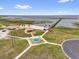 Scenic view of a lake with a pier and gathering spaces, perfect for outdoor relaxation and community events at 2430 Park Ave, Indian Lake Estates, FL 33855