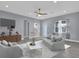 Cozy living room featuring a modern ceiling fan, stylish furniture, and ample natural light at 2430 Park Ave, Indian Lake Estates, FL 33855