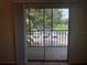 View from the balcony, overlooking the parking lot and green space at 2597 Oak Park Way # 205, Orlando, FL 32822