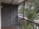 View from balcony overlooking the parking lot and trees at 2597 Oak Park Way # 205, Orlando, FL 32822