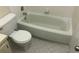 Cozy bathroom featuring a toilet, tub, and tiled floor at 2597 Oak Park Way # 205, Orlando, FL 32822