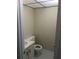 A compact half bathroom with a pedestal sink and toilet and a gray tile floor at 2597 Oak Park Way # 205, Orlando, FL 32822