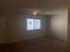 Bright bedroom with closet, neutral walls, carpet, and view to exterior through large window at 2597 Oak Park Way # 205, Orlando, FL 32822