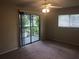 Bedroom with a ceiling fan, and sliding glass door to the balcony at 2597 Oak Park Way # 205, Orlando, FL 32822